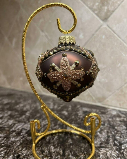 Matte cocoa onion dome Christmas ornament with glittered star and bronze crystals on a gold stand, Pluma Fine Art